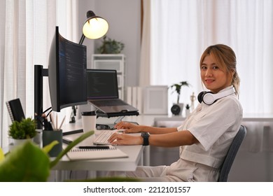 Young female developer working with coded data on computer screen. Developing programming and coding technologies concept