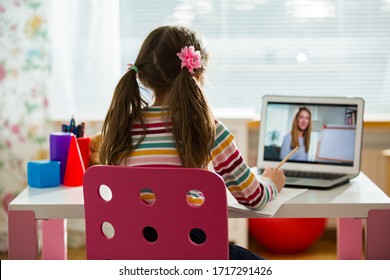 Young female distance teacher having video conference call with pupil using webcam. Online education and e-learning concept. Home quarantine distance learning and working from home. - Powered by Shutterstock