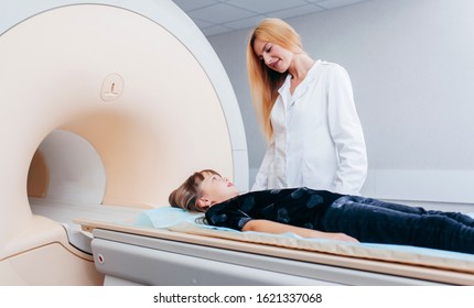 Young Female Doctor And Child In MRI Room 