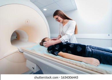 Young Female Doctor And Child In MRI Room 