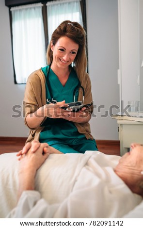 Female doctor comforting older patient