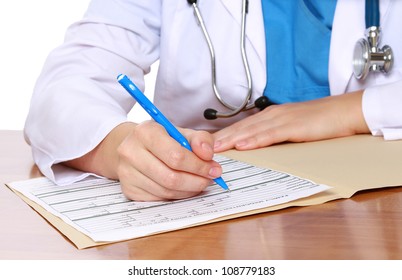 Young Female Doctor At Desk Isolated. Selective Focus