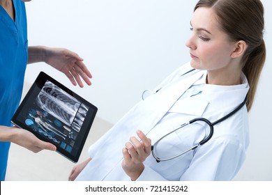 Young Female Doctor Meeting With A Nurse.