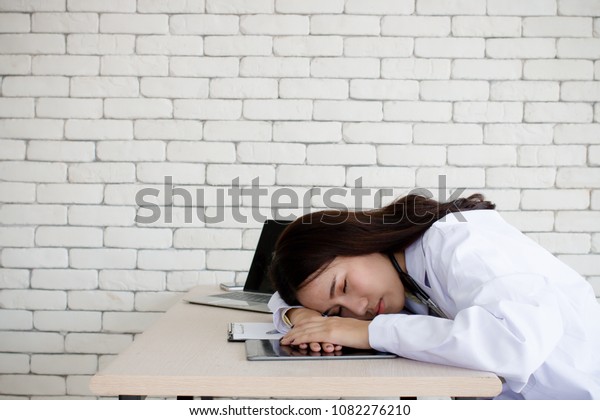 Young Female Doctor Sleeping Her Desk Stock Photo Edit Now