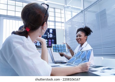 Young Female Doctor Student Internship Team Group Meeting And Discussing About Brain Cancer Surgery Treatment Patient Case At The Lab Office In Hospital. Healthcare And Medical Education Concept.