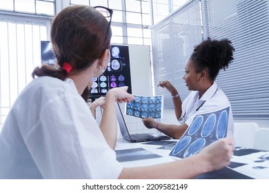 Young Female Doctor Student Internship Team Group Meeting And Discussing About Brain Cancer Surgery Treatment Patient Case At The Lab Office In Hospital. Healthcare And Medical Education Concept.