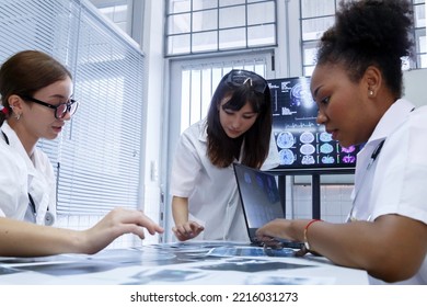 Young Female Doctor Student Internship Team Group Meeting And Discussing About Brain Cancer Surgery Treatment Patient Case At The Lab Office In Hospital. Healthcare And Medical Education Concept.