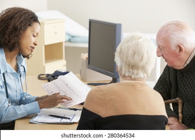 Young Female Doctor Talking To Senior Couple