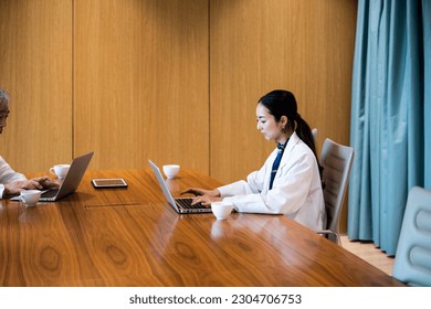 Young female doctor using a laptop - Powered by Shutterstock