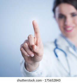 Young Female Doctor Using A Touch Screen Interface.