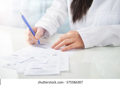 Young Female Doctor Writing A Prescription.