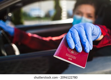 Young Female Driver Handing Over Red Passport To Security Officer Through Car Window,border Crossing Check During COVID-19 Pandemic,Coronavirus Immunity Passport Certificate As Proof Of Vaccination