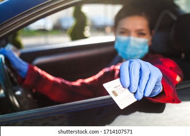 Young Female Driver Showing Coronavirus Health Card ID Immunity Passport,proof That A Person Has Developed Resilience,COVID-19 Risk Free Certificate,hand Holding Identification Through Car Window