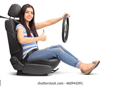 Young Female Driver Sitting On A Car Seat And Giving A Thumb Up Isolated On White Background