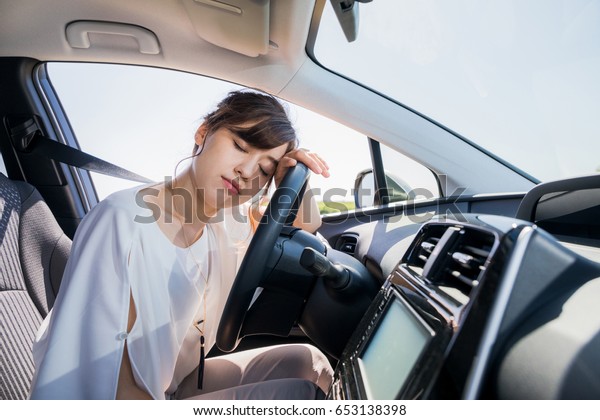 young female driver\
sleeping in vehicle.
