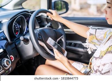 Young Female Driver Using A Phone While Driving, Indicating Negligence