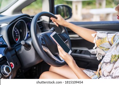 Young Female Driver Using A Phone While Driving, Indicating Negligence