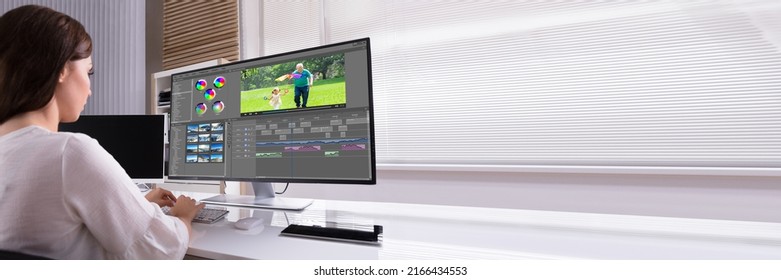 Young Female Editor Editing Video On Computer In Office