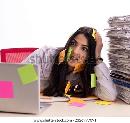Young female employee in conflicting priorities concept
