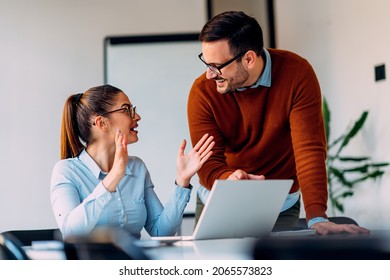 Young female employee consulting with manager