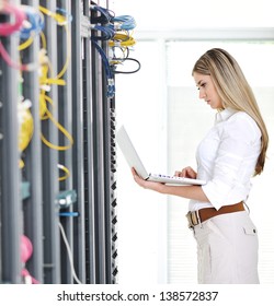 Young Female Engineer Businesswoman With Modern Laptop In Network Server Room