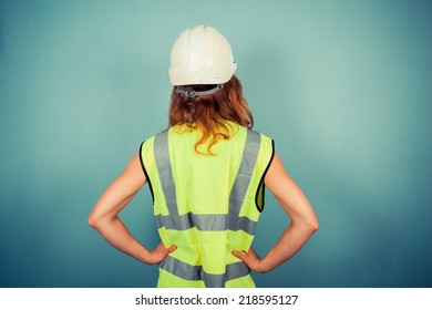A Young Female Engineer Is Wearing A High Vis Vest And A Hardhat