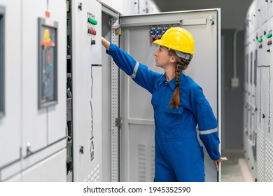 Young female engineer working in electrical control room in the heavy factory, Professional industrial engineer women operating in electricity substation