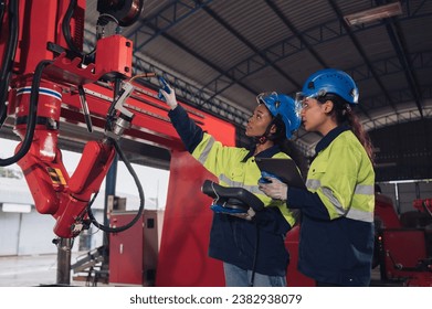 Young female engineers, experts in computer maintenance, are used to create work systems in warehouses and factories. They work together - Powered by Shutterstock