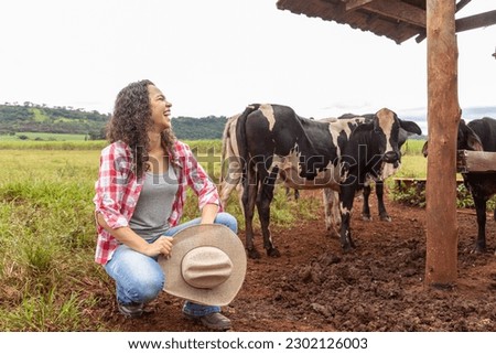 Young female farmer on the farm pasture