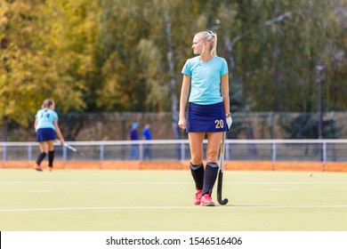 Young Female Field Hockey Player With Stick On The Field