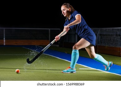 Young female field hockey player performing short or penalty corner - Powered by Shutterstock