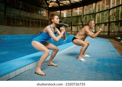 Young female fitness instructor training adult sportsman at swimming pool - Powered by Shutterstock