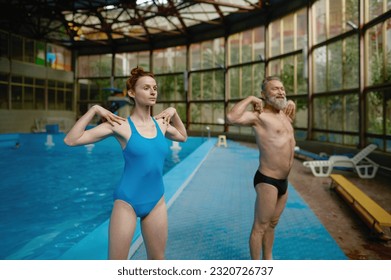 Young female fitness instructor training adult man at swimming pool - Powered by Shutterstock