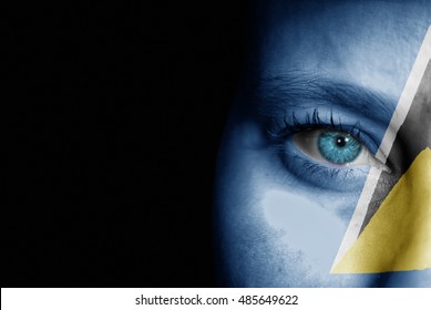 A young female with the flag of St Lucia painted on her face on her way to a sporting event to show her support.