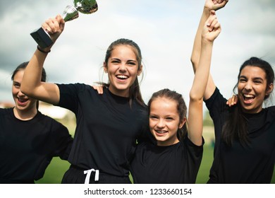 Young female football players celebrating their victory - Powered by Shutterstock