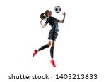 Young female football or soccer player with long hair in sportwear and boots kicking ball for the goal in jump isolated on white background. Concept of healthy lifestyle, professional sport, hobby.