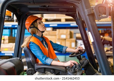 Young Female Forklift Driver Working In A Warehouse