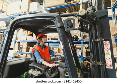 Young Female Forklift Driver Working In A Warehouse