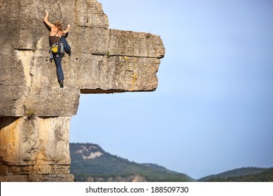 Young Female Free Climber On A Cliff 