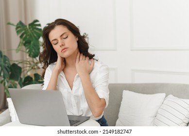 Young female freelancer working from home and experiencing neck pain. Lots of work from home - Shutterstock ID 2149182747