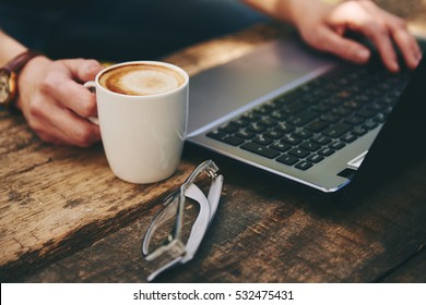 Young female freelancer working online at computer in the morning.  Concept of networking and occupation. 
