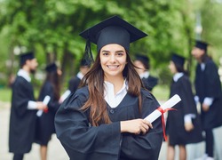 A Young Female Graduate Against The Background Of University Graduates.