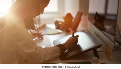 Young female graphic designer sketching on her project with modern creative work place   - Shutterstock ID 1456062572
