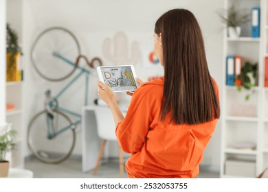 Young female graphic designer with tablet computer in office, back view - Powered by Shutterstock