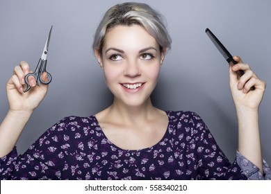 Young Female Hairdresser With Scissors And Comb Advertising For A Cosmetology School Or A Salon.  The Image Depicts Trendy Styles And Hair Color. 
