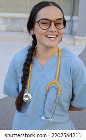 Young Female Health Care Worker Wearing Blue Scrubs 