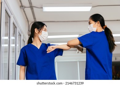 Young Female Healthcare Workers Wearing Surgical Mask Shaking Hands With Elbow Bump While Maintaining Social Distancing During The Outbreak Of Corona Virus Pandemic