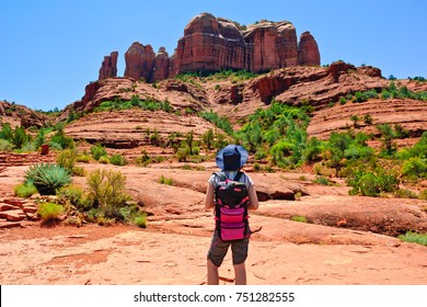 A Young Female Hiker Deciding To Hike Cathedral Rock Located In Sedona Arizona. Because The Girl Is Facing Away From The Camera And Is Wearing Generic Attire A Model Release Is Not Necessary.