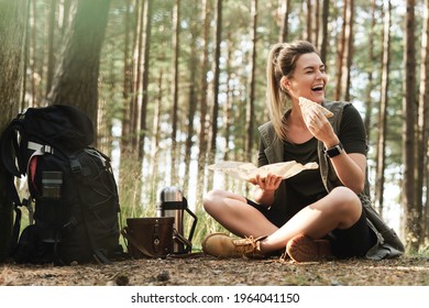 Young Female Hiker During Small Halt Eating Sandwich In Green Forest