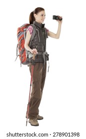 Young Female Hiker Holding Camera Isolated On White Background, Standing In Full Length Wearing Outdoor Hiking Outfit.